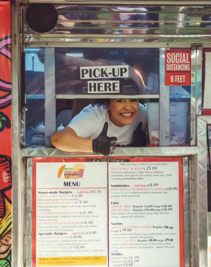 Smiling staff member at a SactoMoFo food truck in Sacramento, ready for mobile foods pick-up for Corporate and Private Catering