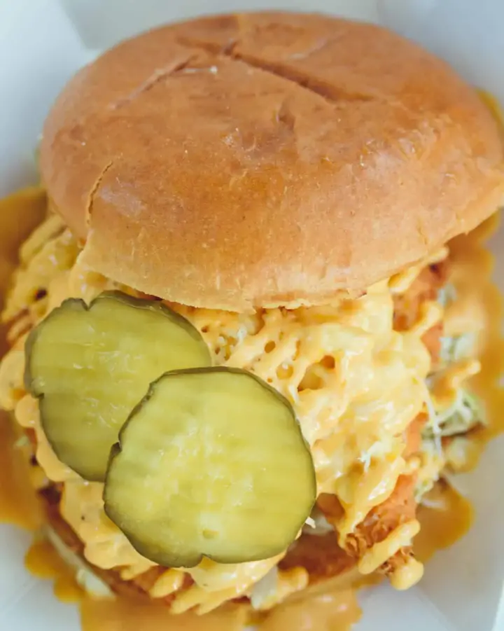 Close-up of a delicious sandwich with pickles from a SactoMoFo food truck in Sacramento, perfect for mobile foods and workplace lunch options